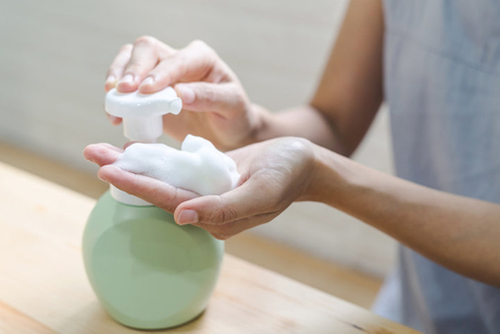 Close up of woman hand take cleaner foam.jpg