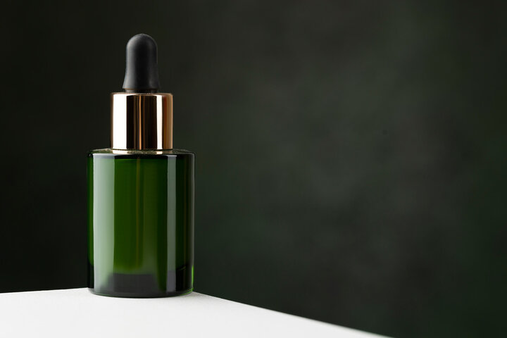 Green glass serum cosmetics bottle