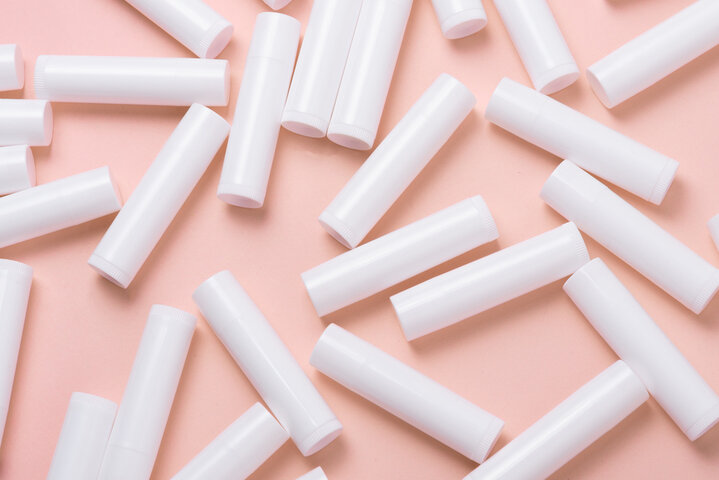 Lot of white plastic lip gloss tubes