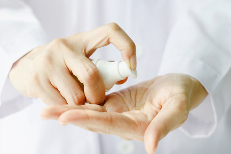 Closeup of female scientist hands testing texture of beauty products..jpg