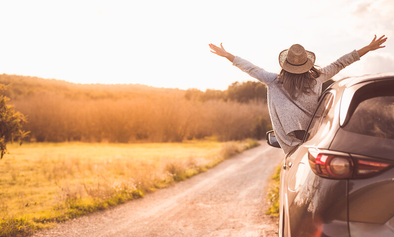 Happy girl celebrating success at sunset